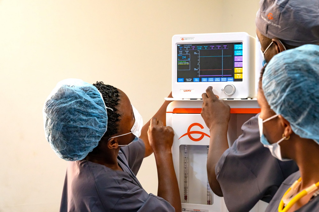 Trainees point at a Gradian Health product screen